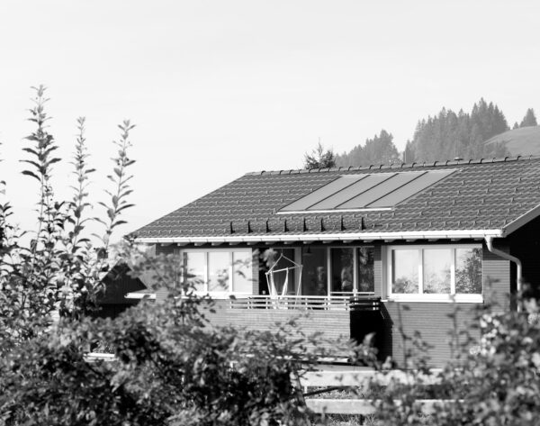 Hausdach eines Einfamilien Neubau Hauses in Dornbirn Kehlegg mit Sonnenkollektoren und einem Schneefangsystem.